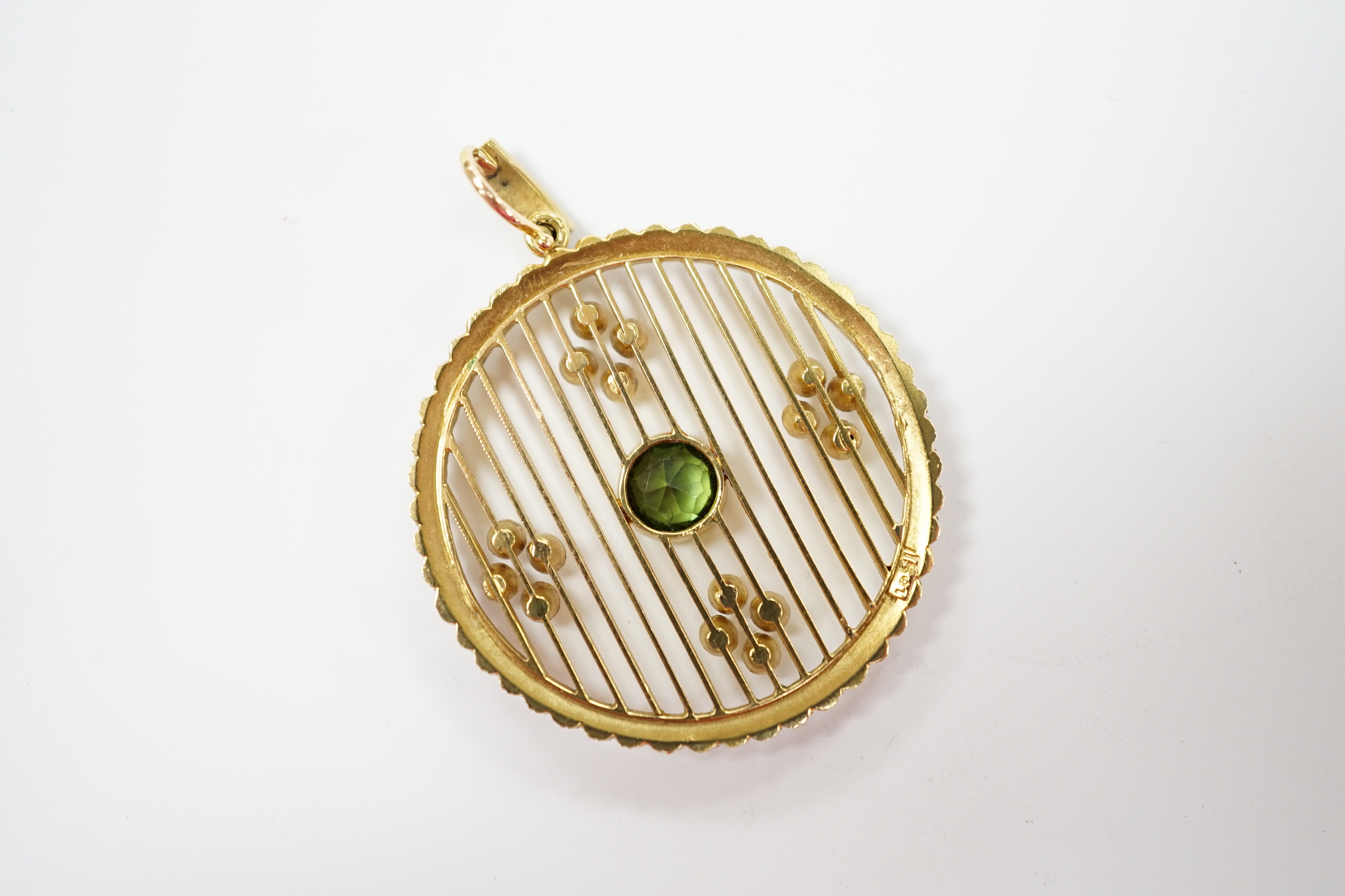 An Edwardian 15ct, green tourmaline and seed pearl cluster set circular pearl pendant, overall 41mm, gross weight 7 grams.